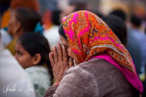 Environmental portrait: Profile of an Indian woman in prayer, Haridwar India