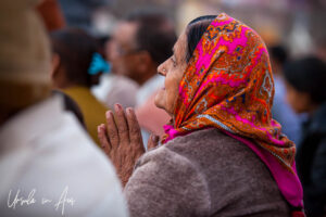 Environmental portrait: Profile of an Indian woman in prayer, Haridwar India