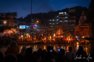 Lights, flames, Hindu priests, and lay-people crowded onto Har Ki Pauri ghat after dark, Haridwar, India