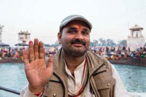 Environmental portrait: Smiling Indian man, Haridwar ghat India