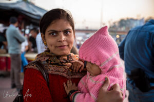 Environmental portrait: A woman with a baby, Haridwar ghats India