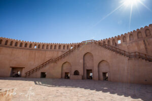 Sun flare over the walls of Nizwa Fort, Oman.