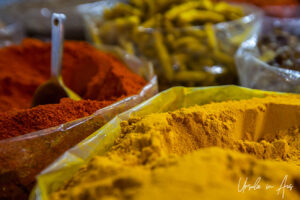 Close up: bags of yellow and red spice powders, Nizwa Souq, Oman.