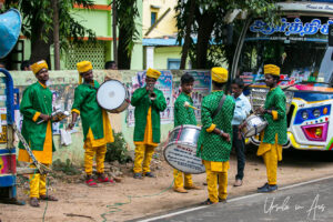 Tamil men in green and yellow outfits with brass instruments and drums, Thanjavur India