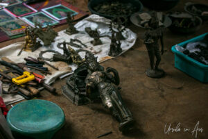 Small bronze figure of Dewi Sri on a rough floor, Thanjavur, Tamil Nadu, India