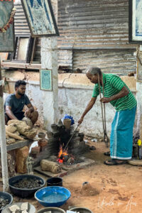 Craftsman melting bronze on an open fire, Thanjavur, Tamil Nadu, India