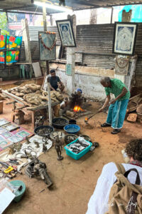 Craftsman pouring liquid bronze into a mould, Thanjavur, Tamil Nadu, India