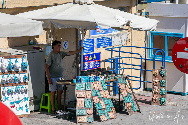Man looking after a souvenir stand, Heraklion Crete Greece.