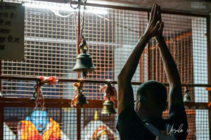 Man praying to Hindu gods in a cage, Kunjapuri Temple, Uttarakhand, India