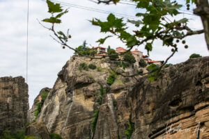 Holy Monastery Great Meteoron through the trees across the plateau, Meteora, Greece