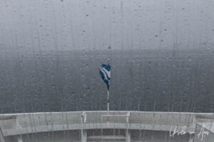 BC Ferries flag on a rainy prow, Inside Passage, Canada.