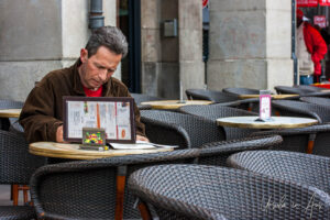 Man at a coffee shop table, Toulouse, France