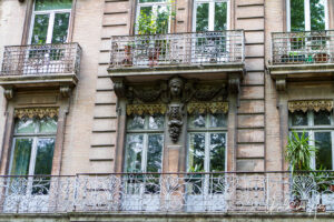 Old apartment front on a leafy street, Toulouse France