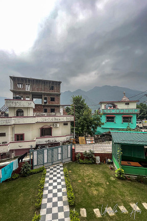 Grass surrounded by three multi-story buildings, Rishikesh, India