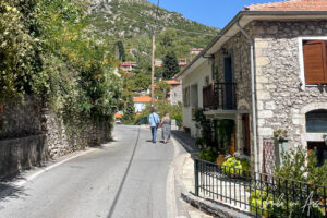 A couple walking in a Stemnítsa street, Greece