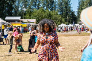 Flávia Nascimento dancing in the grass, Vancouver Island Musicfest, Comox Canada