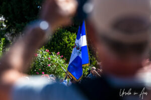 Looking through a crowd at a regimental flag, Syntagma Square, Athens, Greece