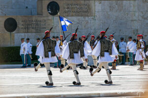The back of three marching Greek Presidential Guards in front of the Tomb of the Unknown Soldier, Athens.