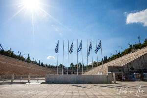 Sun and flags in the Panathenaic Stadium, Athens, Greece