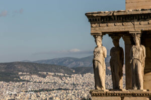 The Caryatids, on the Erechtheion with Athens in the background, Greece.