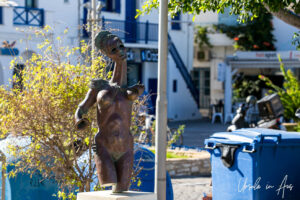 A modern bronze sculpture of an armless woman, Parikia, Paros Greece.