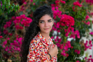 Portrait: woman against bougainvillia, Parikia, Paros Greece.