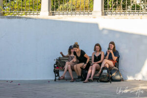 Four young women on a bench, Lefkes Paros Greece.