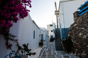Paved street flanked with whitewashed buildings, Lefkes Paros Greece.