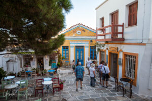 A courtyard flanked with shops and restaurants, Lefkes Paros Greece.