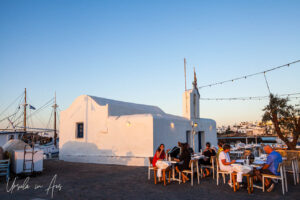 Courtyard full of restaurant tables, outside the Chapel of Agios Nikolaos, Naoussa Paros Greece
