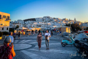 Blue light over walkers in Naoussa Town Square, Paros Greece