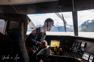 A young man on the bridge of a catamaran, Prince Rupert Adventure Tours, BC Canada