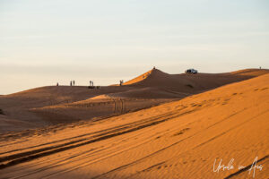 People on the dunes in the distance, Erg Chebb, Morocco.