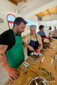 A woman coring a red capsicum, Platia, Naxos Greece