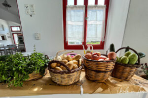 Baskets of vegetables in front of window, Platia, Naxos Greece