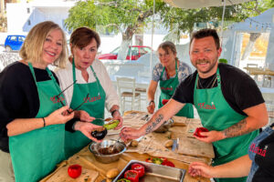Four travellers stuffing capsicum, Platia cooking school, Naxos Greece