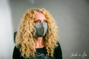 Portrait: Blond woman in a mask, Vallindras Kitron Distillery, Halki Naxos Greece.