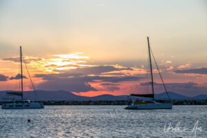 Red sky behind sailboats on Naxos Harbour, Greece
