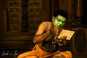 Portrait: Man painting stage makeup on his face, Great K V Kathakali Center in Fort Kochi, Kerala India