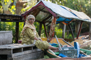 Environmental portrait: woman on a wooden pier, Dal Lake, Jammu and Kashmir, India