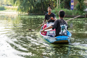 Two men in a rowboat, Dal Lake, Jammu and Kashmir, India