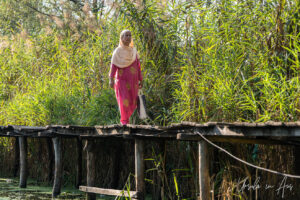 Woman walking on a walkway, Dal Lake, Jammu and Kashmir, India