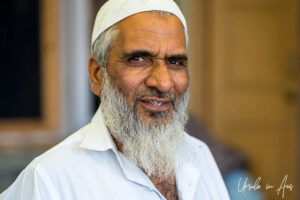 Environmental portrait: A Kashmiri man in a white topi, Srinagar, Jammu and Kashmir, India
