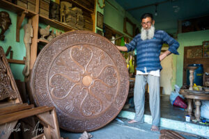 A Kashmiri man with a carved walnut table-top, Srinagar, Jammu and Kashmir, India