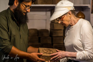 A woman buying a wooden box from a man, Srinagar, Jammu and Kashmir, India