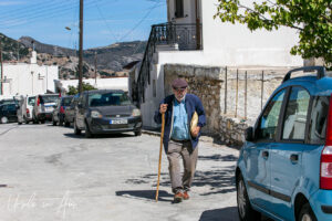 Elderly man walking in the street, Apeiranthos, Naxos, Greece