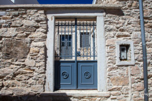 Decorative metal doorway in a marble wall, Apeiranthos, Naxos, Greece
