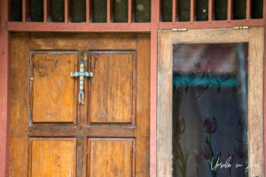 A simple woven cross on a wooden door, Kwatisore, Indonesia