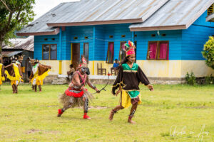 Young Papuans dancing their bird of paradise dance, Kwatisore, Indonesia