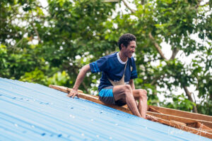 Man on a roof, Kwatisore, Papua Indonesia